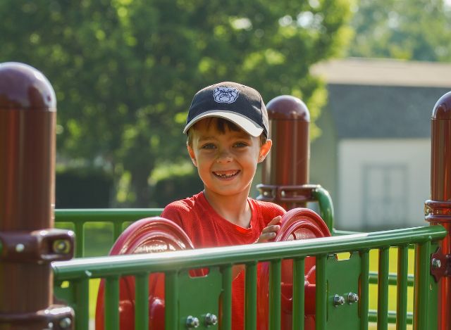 happy boy driving the playground equipment